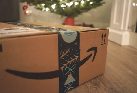 Amazon delivery box with gifts in front of a Christmas tree