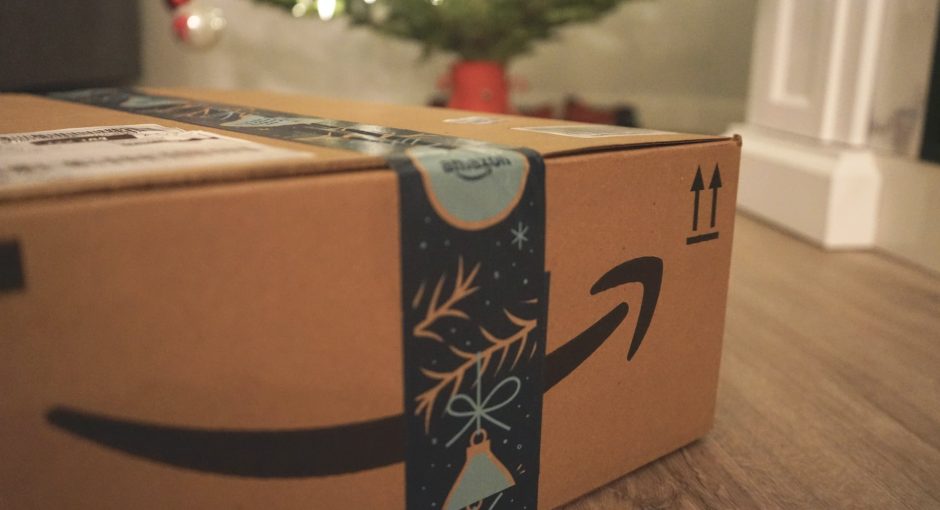 Amazon delivery box with gifts in front of a Christmas tree