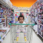 Baby on white shopping cart