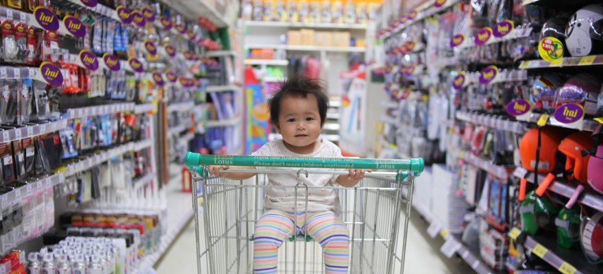 Baby on white shopping cart
