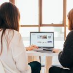 Two women looking at laptop computer