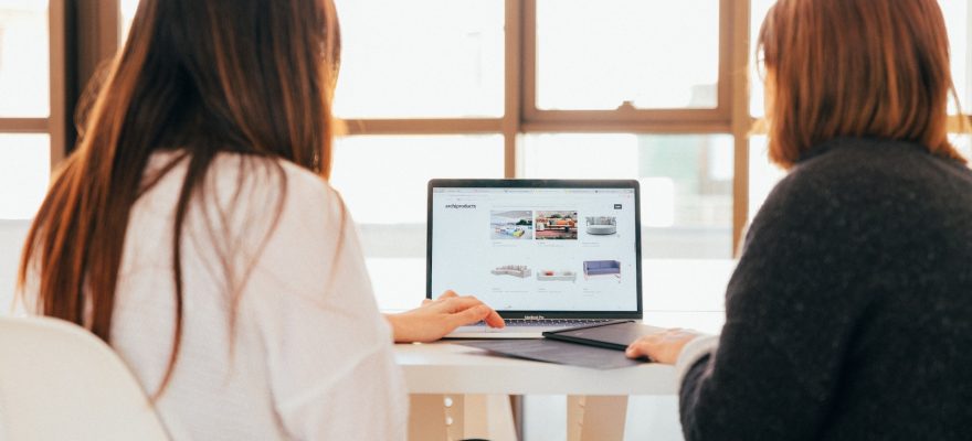 Two women looking at laptop computer