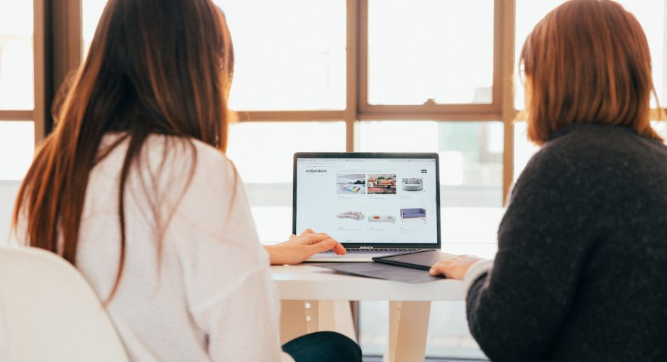 Two women looking at laptop computer