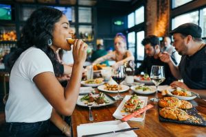 Woman in white shirt eating
